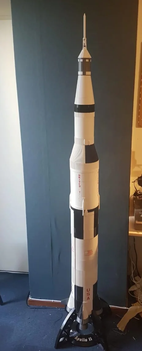 Tall rocket display model mounted on a dark base