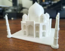 White domed building model with four slender towers